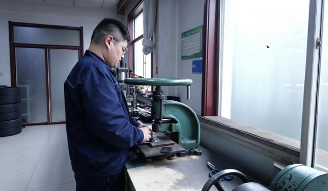 JABIL technician performing rubber sample quality testing